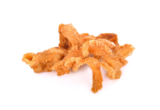 istock pile of fried pork rinds on white background 1024352660