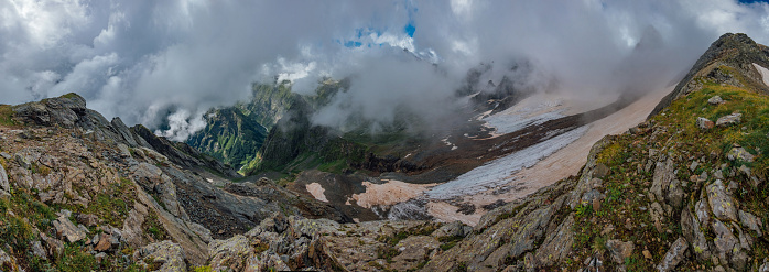 Panorama of high Caucasian mountains in clouds.