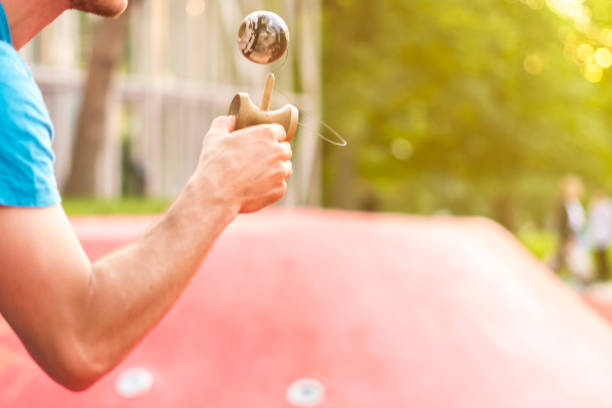 close up hands playing kendama japaneese toy in street close up hands playing kendama japaneese toy in the street kendama traditional japanese toy stock pictures, royalty-free photos & images