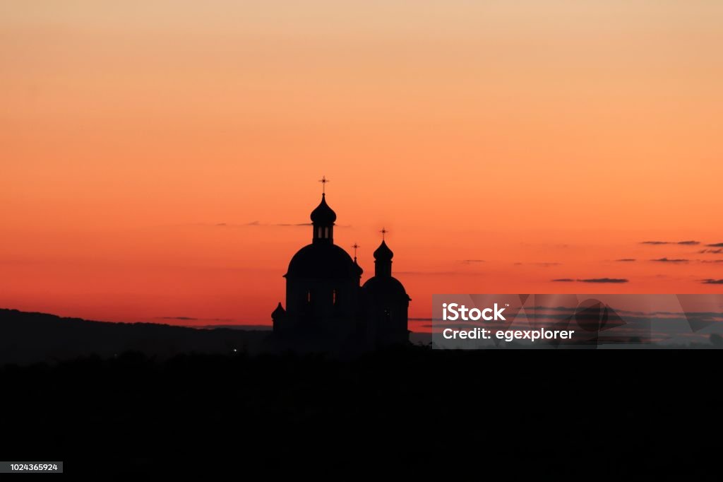 Silhouette of an orthodox church at dusk. Orthodox Church visible from far away at sunset. Romania Stock Photo