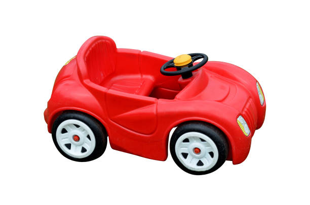 roten spielzeugauto, isoliert auf weißem hintergrund - spielzeugauto stock-fotos und bilder