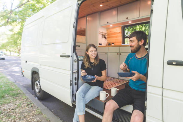 istock Millennial couple eat breakfast in their live-in van 1024370986