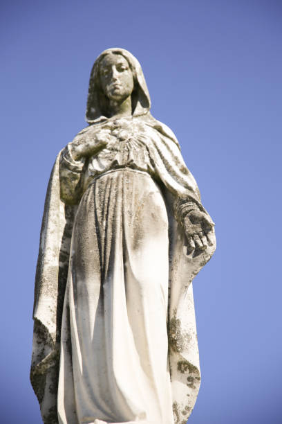 istock Low Angle Virgin Mary Immaculate Heart Statue, Blue Background 1024371634