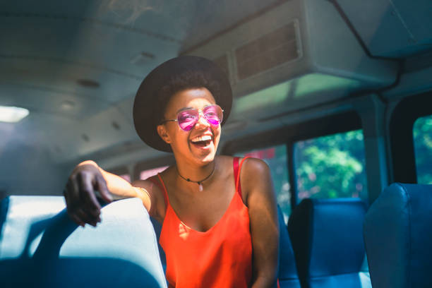 A cheerful young adult sitting in the bus
