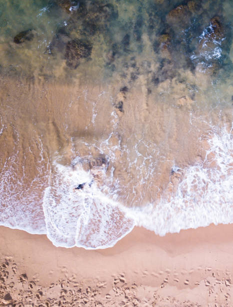 istock Aerial view of waves on the beach 1024377376