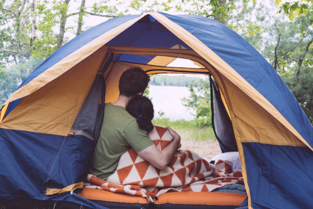 istock Couple sitting in tent at campground 1024444352
