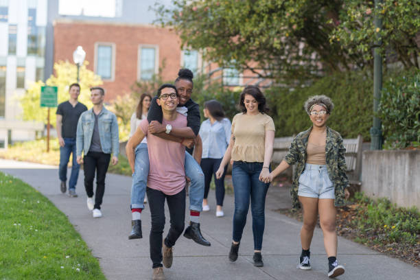 istock Group photo of college students on campus sidewalk together 1024450424