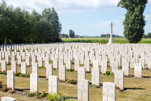 A vast number of tombstones, in autumn, at the Brandhoek New Military in Flanders Belgium. The soldiers names , rank and unite information is engraved on their gravestones.