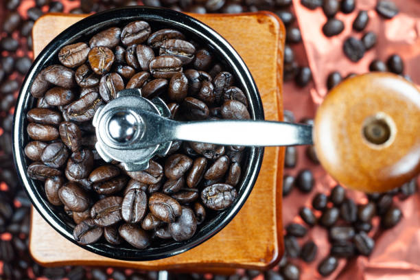 istock Coffee beans and vintage wooden grinder. 1024511322