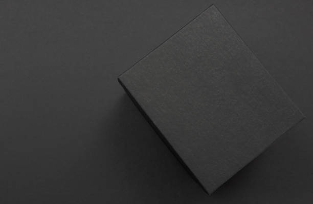 Black and white polka dot gift box on a dark contrasted background, creating a romantic atmosphere. Typically used for birthday, anniversary presents, gift cards, post cards.