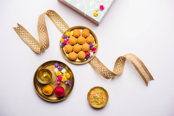 Raksha bandhan Festival : conceptual Rakhi made using plate full of Bundi Laddu sweet with band and Pooja Thali. A traditional Indian wrist band which is a symbol of love between Brothers and Sisters Raksha bandhan Festival : conceptual Rakhi made using plate full of Bundi Laddu sweet with band and Pooja Thali. A traditional Indian wrist band which is a symbol of love between Brothers and Sisters raksha bandhan stock pictures, royalty-free photos & images