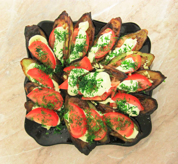 istock Fried eggplants and fresh tomato with souce and herbs 1024526432