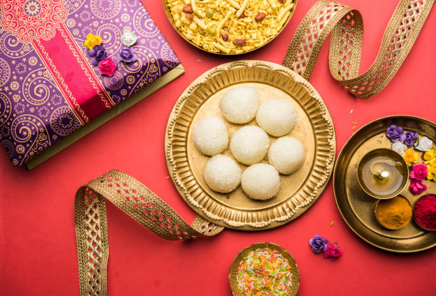 Raksha bandhan Festival : conceptual Rakhi made using plate full of Rasgulla sweet with band. A traditional Indian wrist band which is a symbol of love between Brothers and Sisters stock photo