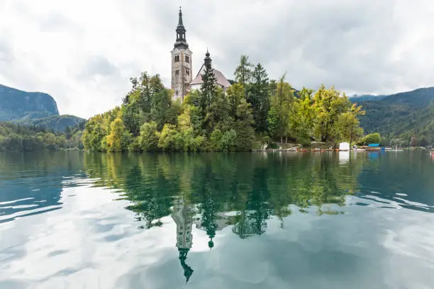 Reflection of the Pilgrimage Church of the Assumption of Maria on the surface of Lake Bled, Slovenia