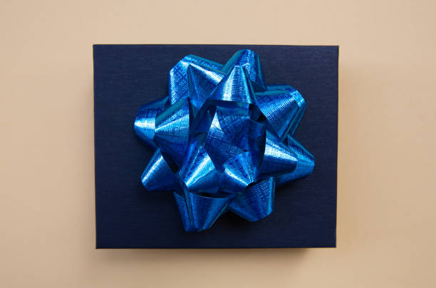 istock Black gift box on a dark contrasted background, decorated with a blue color bow, creating a romantic atmosphere. Typically used for birthday, anniversary presents, gift cards, post cards. 1024540818
