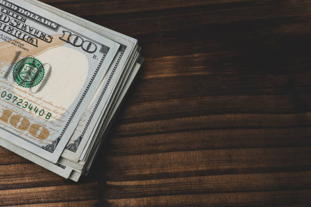 istock Stack of money on wooden table. 1024540922