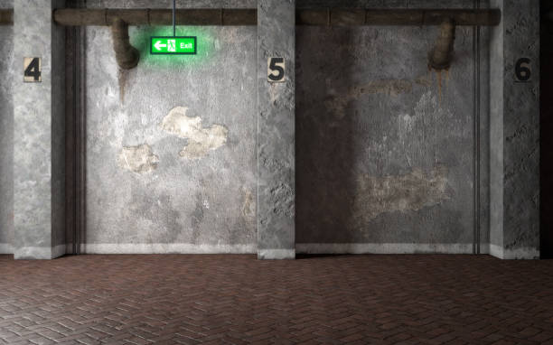 istock Industrial interior room with concrete walls and glowing exit sign. 3d rendering 1024546192