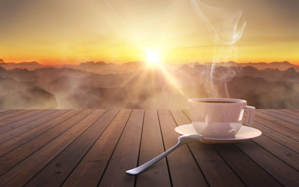 Close up coffee cup on wooden table at sunset