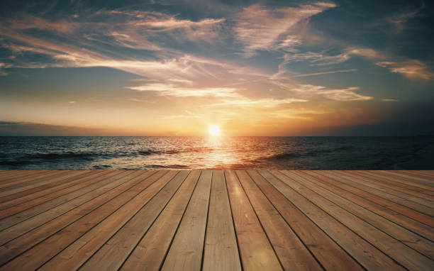 istock Empty wooden deck and beautiful sunset on the sea 1024548900