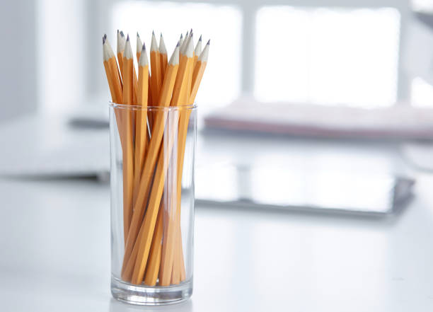 istock Graphite pencils in a glass cup on the office table. Concept 1024551974