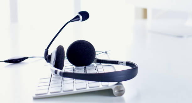 istock Call center and customer service help desk. VOIP headset on lap 1024552696