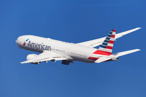 American Airlines Boeing 777-200ER Banking Barcelona, Spain - August 21, 2018: American Airlines Boeing 777-200ER banking left after taking off from El Prat Airport in Barcelona, Spain. 777 stock pictures, royalty-free photos & images