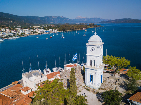 Aerial drone bird's eye view photo of the clock tower of Poros island, Greece.