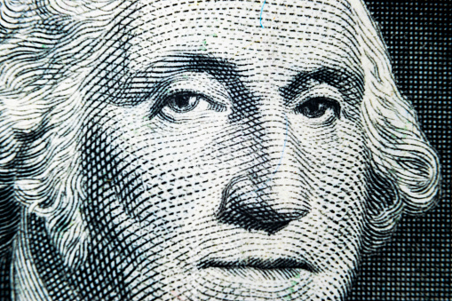 US president George Washington face portrait on the USA one dollar note. Macro shot. Background of the money. George Washington eyes macro shot.