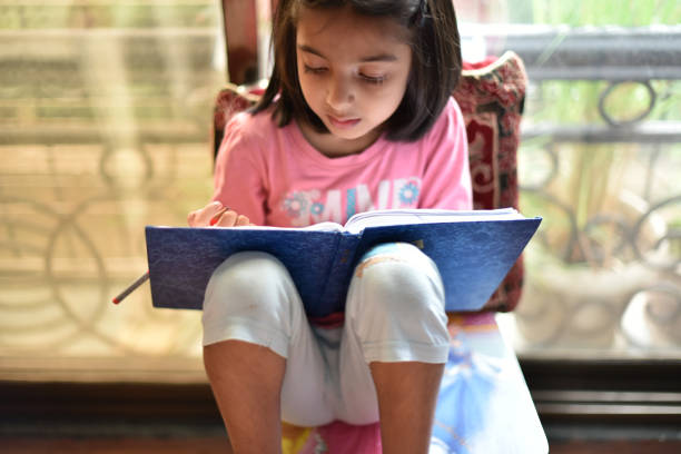istock Young girl writing in the notebook 1024577422