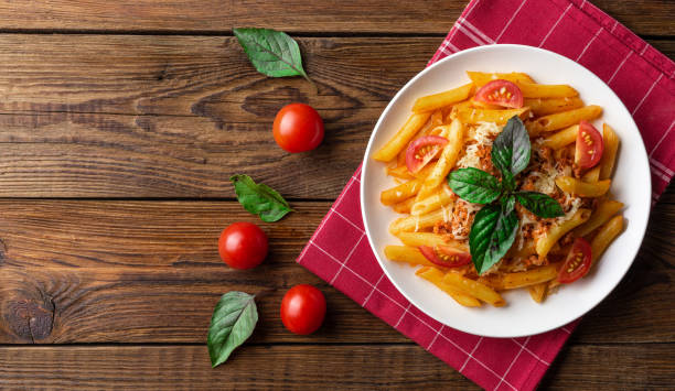 istock Pasta bolognese with tomato sauce and minced meat. Flat lay. Top view. 1024580332