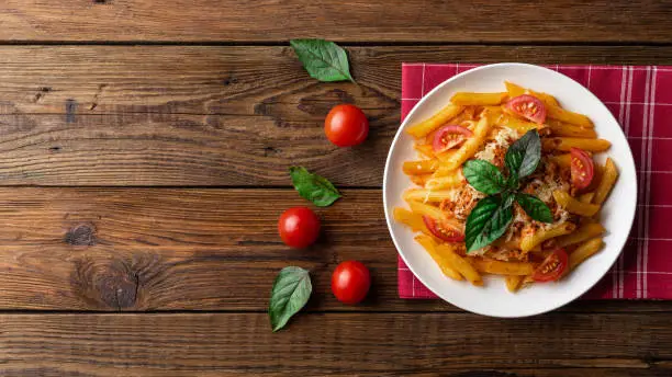 Photo of Pasta bolognese with tomato sauce and minced meat. Flat lay. Top view.