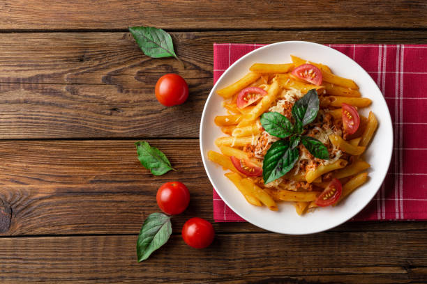 istock Pasta bolognese with tomato sauce and minced meat. Flat lay. Top view. 1024580514