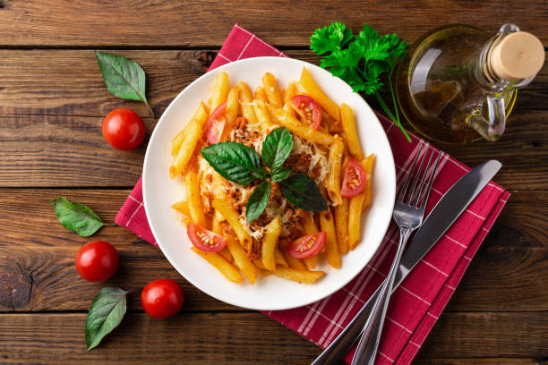 istock Pasta bolognese with tomato sauce and minced meat. Flat lay. Top view. 1024580588