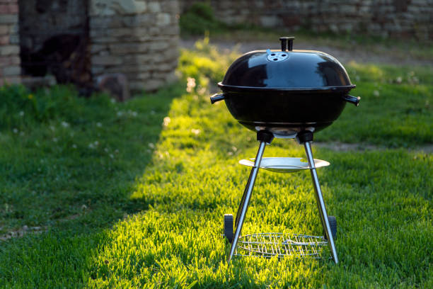 istock BBQ grill outside on the grass backlit by sun 1024592278