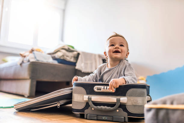 istock Baby sitting in travel suitcase 1024600444