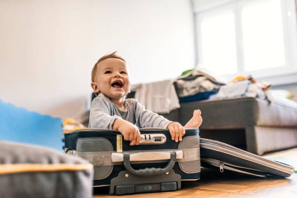 istock Happy baby boy sitting in a suitcase 1024602574