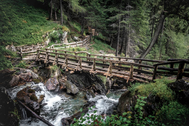 istock wooden bridge and saent waterfall 1024607386