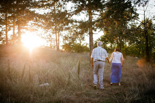 istock Senior couple walking together in nature 1024612262