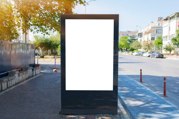Blank white mock up of vertical light box billboard at bus stop station