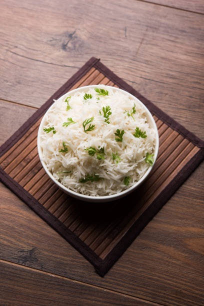 istock Coriander or cilantro Basmati Rice, served in a ceramic or terracotta bowl. It's a popular Indian OR Chinese recipe. Selective focus 1024613728