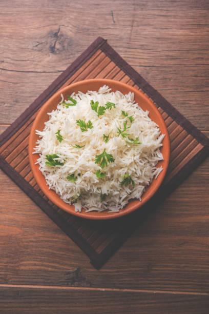 istock Coriander or cilantro Basmati Rice, served in a ceramic or terracotta bowl. It's a popular Indian OR Chinese recipe. Selective focus 1024615998