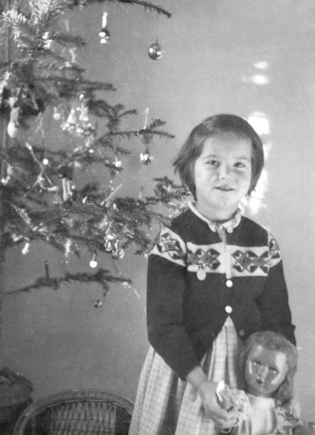 istock 1955 female child playing with christmas tree and doll 1024617352