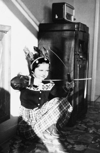 1955 female child playing with bow and arrows