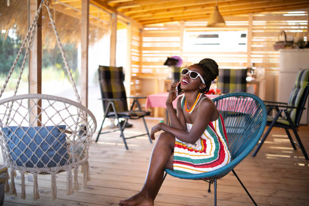 istock Elegant african woman talking on smart phone on bench 1024620616