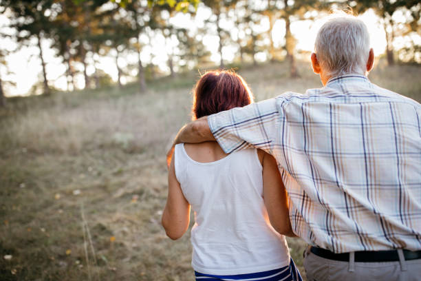 istock Senior couple walking together in nature 1024626860