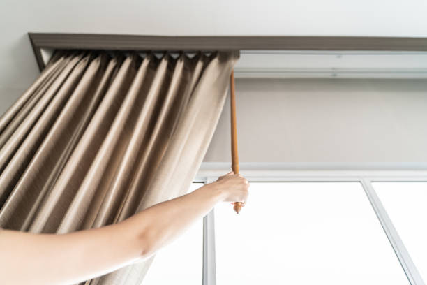 istock woman open and holding the curtains 1024638336