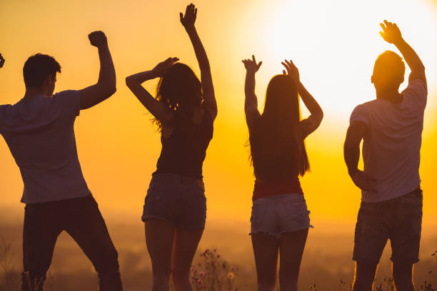istock The four people dancing on the sunset background 1024640900