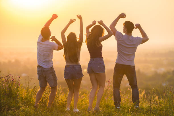 istock The four people dancing on the sunrise background 1024640952