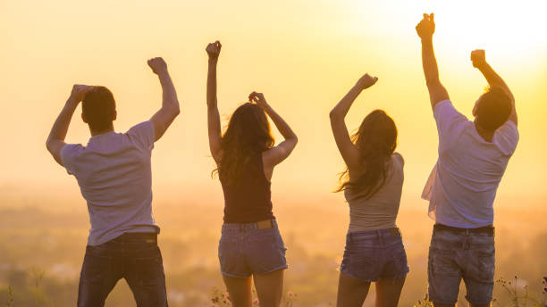 istock The four people dancing on the sunrise background 1024640956