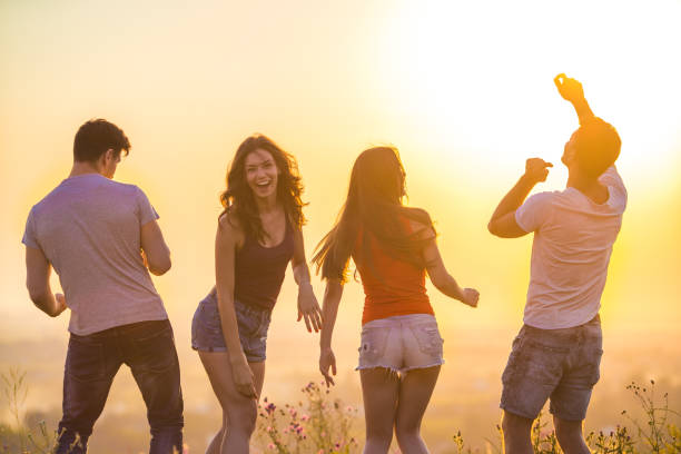 istock The four people dancing on the bright sun background 1024641032
